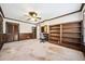 Living room featuring wainscotting, a ceiling fan, neutral paint and carpet, and built-in bookcase at 11514 Sun Rd, Dade City, FL 33525