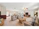 Open-concept living room flows into the kitchen with comfortable seating and natural light at 11514 Sun Rd, Dade City, FL 33525