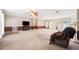 Spacious living room with carpet, ceiling fan, and french doors leading to the exterior at 11514 Sun Rd, Dade City, FL 33525