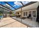 Outdoor patio with tile flooring, dining set and furniture, and glass roof for seamless indoor-outdoor living at 11514 Sun Rd, Dade City, FL 33525