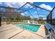 Outdoor pool inside screened enclosure with spacious patio area for relaxation and recreation at 11514 Sun Rd, Dade City, FL 33525