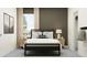 Modern bedroom featuring a cozy bed, stylish nightstands, soothing colors, and natural light from the window at 11546 E 71St Ter, Palmetto, FL 34221