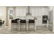 Modern kitchen with white cabinets, stainless steel appliances, a center island with seating, and ample counter space at 11546 E 71St Ter, Palmetto, FL 34221