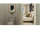 En-suite bathroom featuring toilet and view into bedroom with bed and large window at 11554 71St E Ave, Palmetto, FL 34221