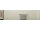Neutral-toned bathroom featuring a towel rack with a neatly hung gray towel and a framed art piece on the wall at 11554 71St E Ave, Palmetto, FL 34221