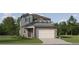 Charming two-story home featuring a gray trim, a well-manicured lawn, and a two-car garage at 11554 71St E Ave, Palmetto, FL 34221