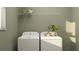 Functional laundry area with modern washer and dryer, overhead shelf, and natural light at 11554 71St E Ave, Palmetto, FL 34221