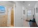 Bathroom featuring a walk-in shower, a door to the backyard, and a laundry area at 11619 80Th Ave, Seminole, FL 33772