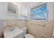 Bathroom with a vanity, a toilet, a mirror, and a window for natural light at 11619 80Th Ave, Seminole, FL 33772