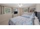 Bright bedroom with twin beds, a ceiling fan, two windows and a mounted TV at 11619 80Th Ave, Seminole, FL 33772