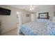 A well-lit bedroom with patterned bedspread, side tables, and bright lighting at 11619 80Th Ave, Seminole, FL 33772