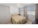 Bedroom featuring a bed, a ceiling fan, two windows and a closet for storage at 11619 80Th Ave, Seminole, FL 33772