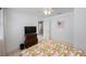 Bedroom featuring a bed, a ceiling fan, a dresser with a TV and an ensuite bathroom at 11619 80Th Ave, Seminole, FL 33772