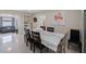 Bright dining room with large table, seating for eight and neutral paint color at 11619 80Th Ave, Seminole, FL 33772