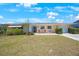 Inviting single-story home with a manicured lawn, quaint seating area, and well-maintained landscaping at 11619 80Th Ave, Seminole, FL 33772