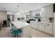 Bright kitchen with white cabinets, stainless steel appliances, and a breakfast bar island at 11619 80Th Ave, Seminole, FL 33772