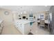 Open-concept kitchen featuring an island with seating, stainless appliances, and dining area at 11619 80Th Ave, Seminole, FL 33772