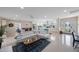 Spacious open-concept living area with tile floors, modern white couch, and seamlessly connected kitchen at 11619 80Th Ave, Seminole, FL 33772