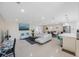 Bright and airy living room with a modern sofa, adjacent dining area, and well-equipped kitchen at 11619 80Th Ave, Seminole, FL 33772