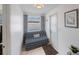 Inviting mud room with a futon, a window, a door to the backyard and a tile floor at 11619 80Th Ave, Seminole, FL 33772