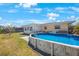 Exterior view of the backyard showing the above ground pool and outdoor lounge area at 11619 80Th Ave, Seminole, FL 33772