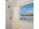 Shower with stainless shower head and bright window at 11619 80Th Ave, Seminole, FL 33772