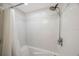 Elegant shower with white tile surround, a shower head, and a bathtub at 11619 80Th Ave, Seminole, FL 33772