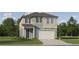 Charming two-story home featuring a two-car garage, well-manicured lawn, and inviting front entry at 11744 E 71St Ter, Palmetto, FL 34221