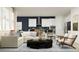 Inviting living room featuring a comfortable sofa, stylish seating, and a modern kitchen in an open layout at 11744 E 71St Ter, Palmetto, FL 34221
