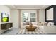 Bright living room features a comfortable sectional sofa, modern media console and large windows providing ample natural light at 11744 E 71St Ter, Palmetto, FL 34221