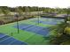 Overhead view of outdoor tennis courts surrounded by greenery and palm trees at 11744 E 71St Ter, Palmetto, FL 34221