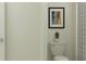 Bathroom features a toilet, a piece of wall art, and a shower with a striped shower curtain at 11848 Blue Diamond Trl, Parrish, FL 34219