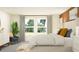 Cozy bedroom showcasing large windows, neutral tones, and stylish modern furniture at 11848 Blue Diamond Trl, Parrish, FL 34219
