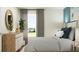 Beautifully decorated bedroom with coastal accents including a side table with a houseplant in a woven basket at 11848 Blue Diamond Trl, Parrish, FL 34219