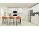 Bright kitchen featuring white cabinets, stainless steel appliances, an island with seating, and ample counter space at 11848 Blue Diamond Trl, Parrish, FL 34219