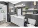 Secondary bathroom features a large mirror, white vanity, and decorative shelves at 12323 Country White Cir, Tampa, FL 33635