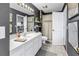 Bathroom featuring a large mirror, white vanity, and shower/tub combination at 12323 Country White Cir, Tampa, FL 33635