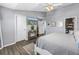 Lovely bedroom features wood-look floors, neutral paint and a TV at 12323 Country White Cir, Tampa, FL 33635
