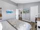 Bedroom with laminate floors, neutral paint, TV and view to second bedroom at 12323 Country White Cir, Tampa, FL 33635