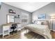 Bedroom features a desk, laminate floors, beach decor and neutral paint at 12323 Country White Cir, Tampa, FL 33635