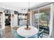 Bright dining area features a white table with blue chairs and a sliding door to the outdoor patio at 12323 Country White Cir, Tampa, FL 33635