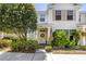 Charming two-story home featuring a welcoming porch, lush landscaping, and a patriotic American flag display at 12323 Country White Cir, Tampa, FL 33635