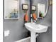 Well-appointed half bathroom featuring a stylish pedestal sink and decorative wall art at 12323 Country White Cir, Tampa, FL 33635