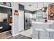 Updated kitchen with stainless steel appliances and a breakfast bar overlooking the adjacent living area at 12323 Country White Cir, Tampa, FL 33635
