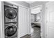 Laundry closet featuring stacked washer/dryer and view into bedroom at 12323 Country White Cir, Tampa, FL 33635