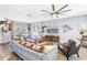 Bright and airy living room featuring modern decor, wood-look flooring, and ample seating for gatherings at 12323 Country White Cir, Tampa, FL 33635