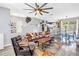 Open-concept living room with stylish furnishings, staircase, and seamless flow to the dining area and kitchen at 12323 Country White Cir, Tampa, FL 33635