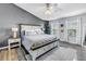 Spacious bedroom featuring a ceiling fan, large windows, and stylish furnishings at 12323 Country White Cir, Tampa, FL 33635