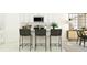 Bright kitchen island with barstool seating, stainless steel appliances, and decorative plant with eat in dining area at 12617 Aura Moonlight Ter, Parrish, FL 34219