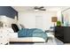 Comfortable bedroom features a ceiling fan, a large bed, dresser, and accent chair creating a serene retreat at 12617 Aura Moonlight Ter, Parrish, FL 34219